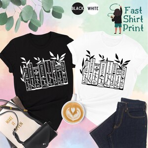 May include: Black and white t-shirts with a graphic of stacked books and the words "Loyal, Ruth, Brave, Deborah, Worship, Lead, Esther, Prayer, Hannah, Redeemed, Rahab, Patience, Faith, Mary." The shirts are displayed with accessories.
