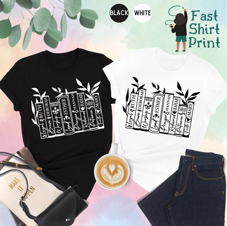 May include: Black and white t-shirts with a graphic of stacked books and the words "Loyal, Ruth, Brave, Deborah, Worship, Lead, Esther, Prayer, Hannah, Redeemed, Rahab, Patience, Faith, Mary." The shirts are displayed with accessories.
