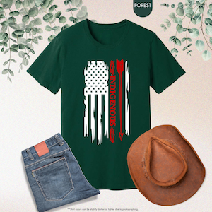 May include: A dark green t-shirt with a distressed American flag design and the word "INDIGENOUS" in red lettering. The flag is overlaid with a red arrow.