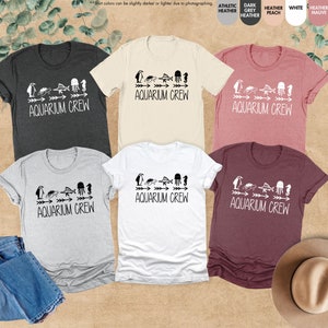 four t - shirts and a hat on a table