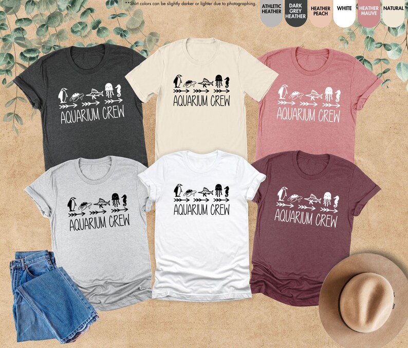 four t - shirts and a hat on a table