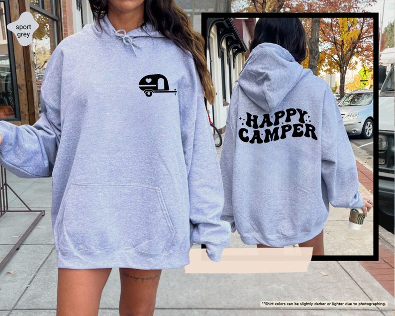 a woman wearing a grey happy camper hoodie