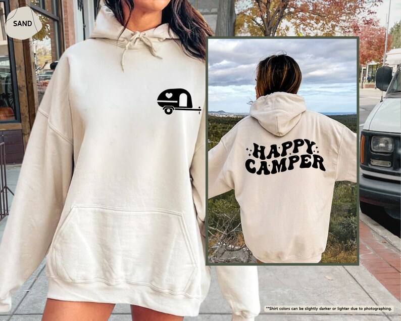 a woman wearing a white happy camper hoodie