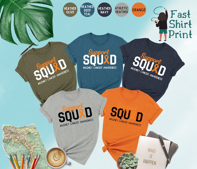 May include: Five t-shirts in different colors with the text "Support Squad" and a ribbon graphic. The text "#Kidney Cancer Awareness" is below the graphic. The t-shirts are heather olive, heather deep teal, heather navy, athletic heather, and orange.