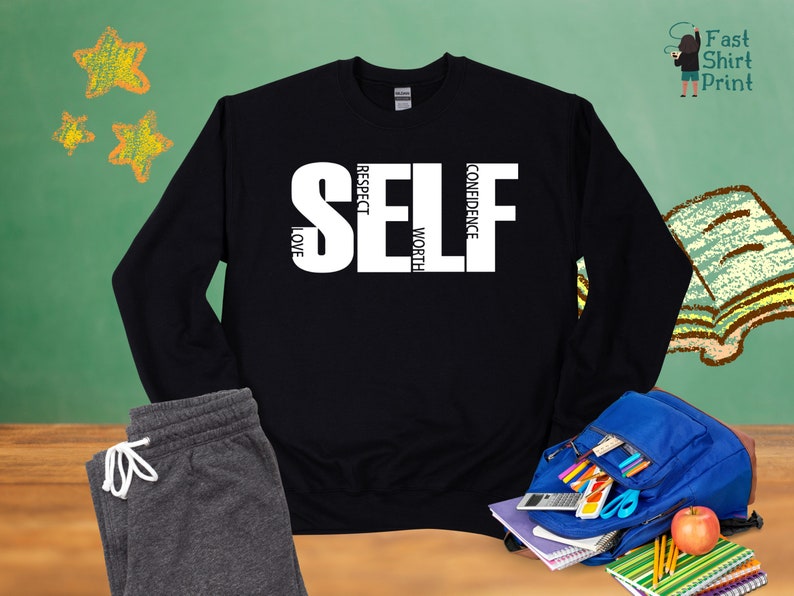 May include: Black sweatshirt with white text that reads "SELF" with the words "CONFIDENCE", "WORTH", "RESPECT", and "LOVE" written vertically around the letters.