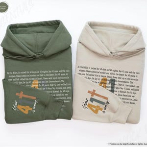 May include: Two hooded sweatshirts in sand and military green colours with the text "Your 41 is coming" in orange, brown, and yellow. The text is accompanied by a cross and the number 41.