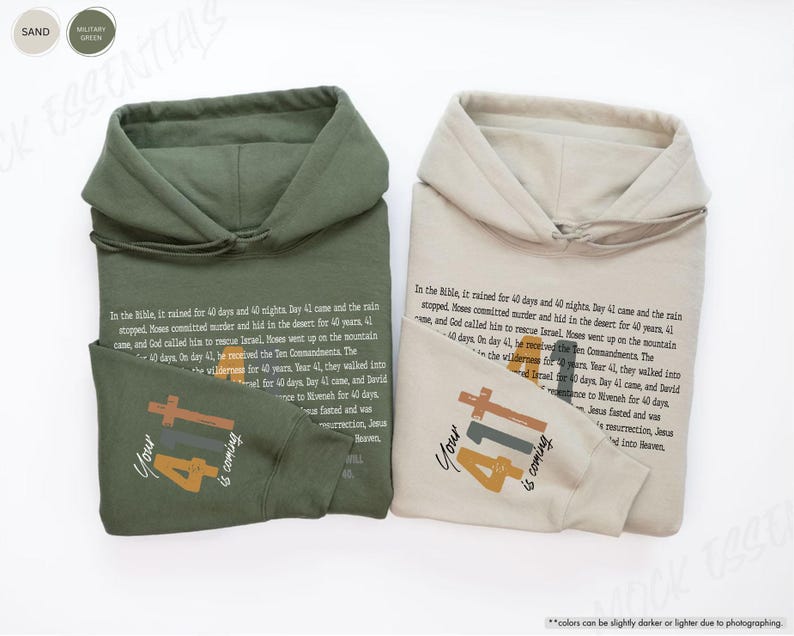 May include: Two hooded sweatshirts in sand and military green colours with the text "Your 41 is coming" in orange, brown, and yellow. The text is accompanied by a cross and the number 41.