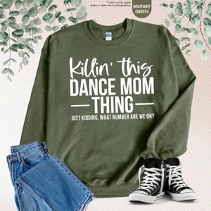 a sweatshirt that says kiln't this dance mom thing with a pair of