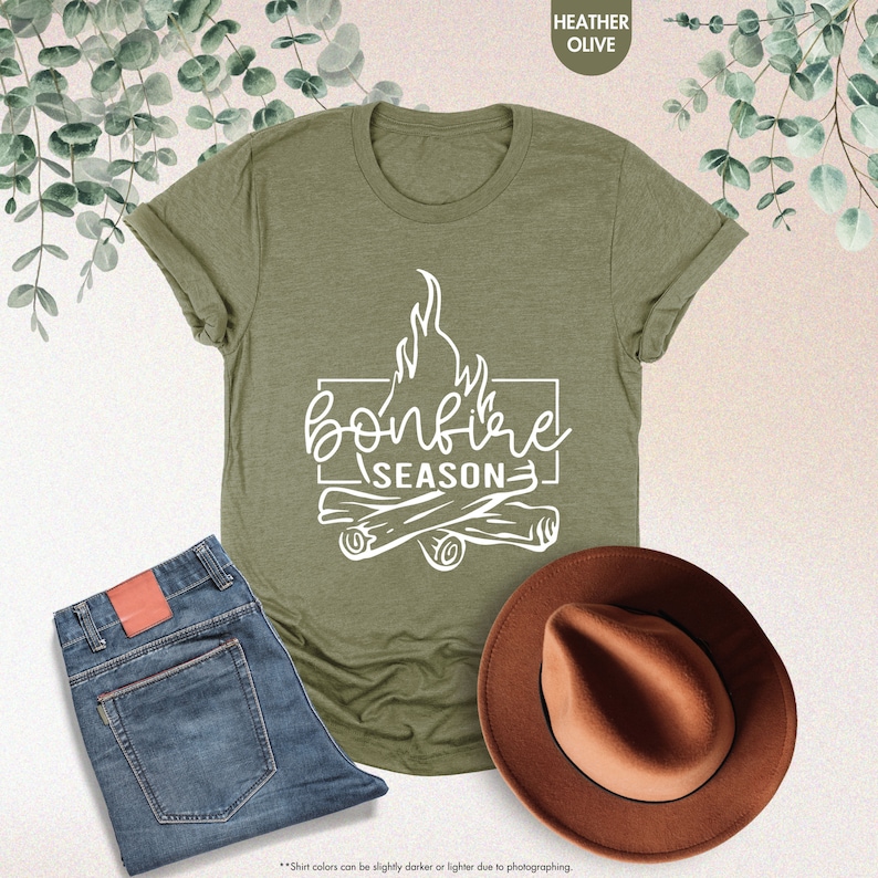 a t - shirt that says bonfire season next to a cowboy hat