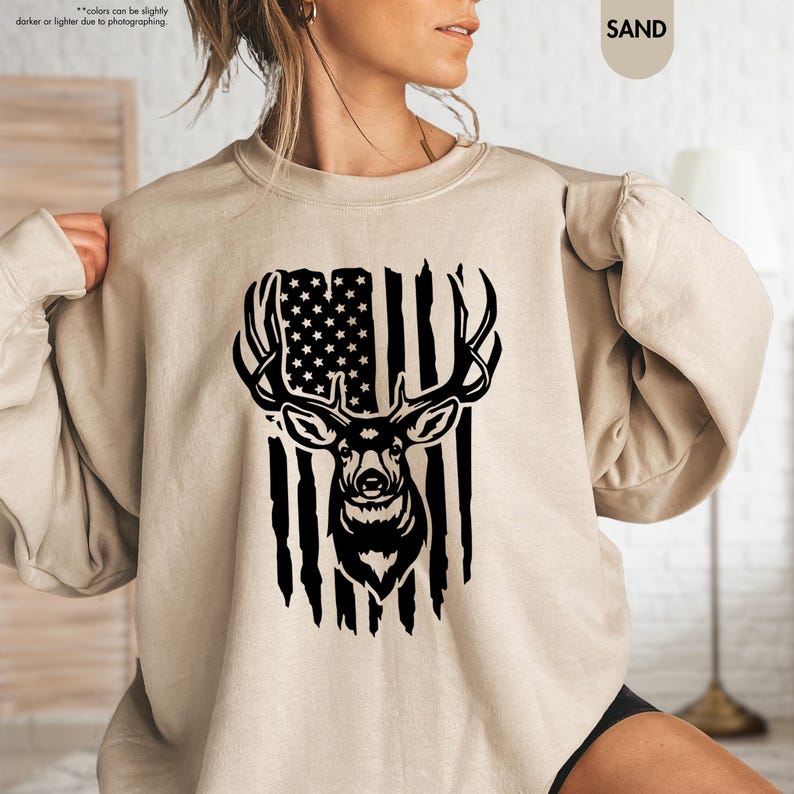 a woman wearing a sweatshirt with an american flag and a deer head