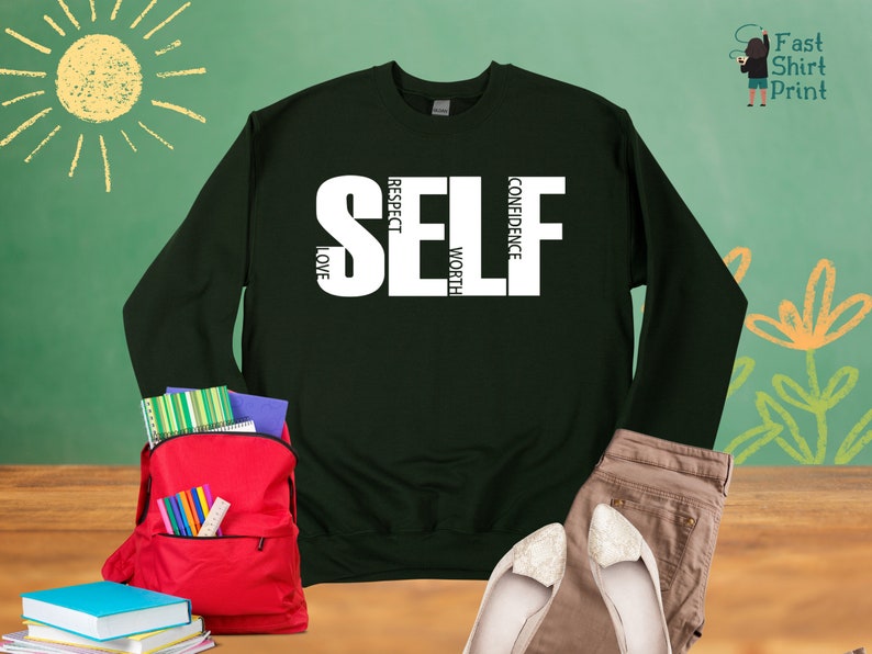 May include: Dark green sweatshirt with white text that reads "SELF" with the words "RESPECT", "LOVE", "WORTH", and "CONFIDENCE" vertically stacked within the letters.