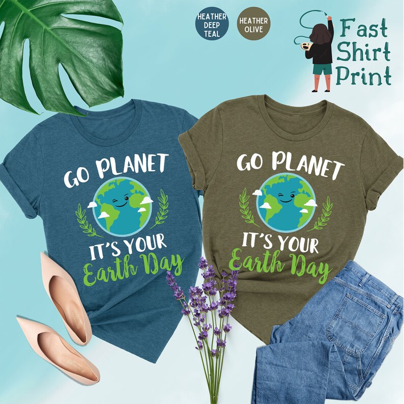 May include: Two t-shirts with a green earth graphic and the text "Go Planet It's Your Earth Day". The shirts are in heather deep teal and heather olive.