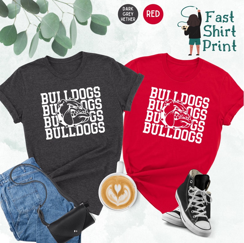 May include: Two t-shirts with the words "Bulldogs" and a bulldog head graphic printed on them. The shirts are in dark grey heather and red.