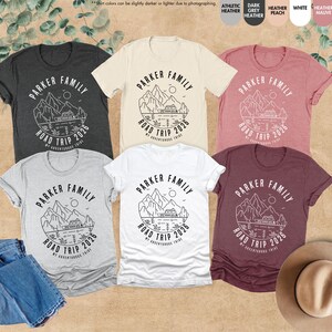 May include: Six short-sleeved t-shirts in shades like grey, white, and burgundy. Each shirt displays a circular graphic with the text "PARKER FAMILY ROAD TRIP 2026" and a mountain and lake design.