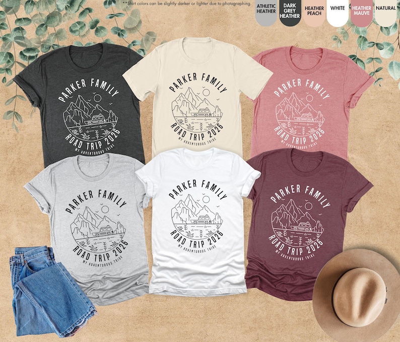 May include: Six short-sleeved t-shirts in shades like grey, white, and burgundy. Each shirt displays a circular graphic with the text "PARKER FAMILY ROAD TRIP 2026" and a mountain and lake design.