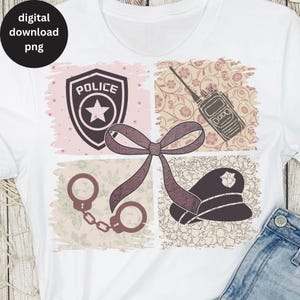May include: A white t-shirt with a pink, brown, and white design featuring a police badge, handcuffs, a police hat, and a walkie-talkie. The design is surrounded by a floral pattern.