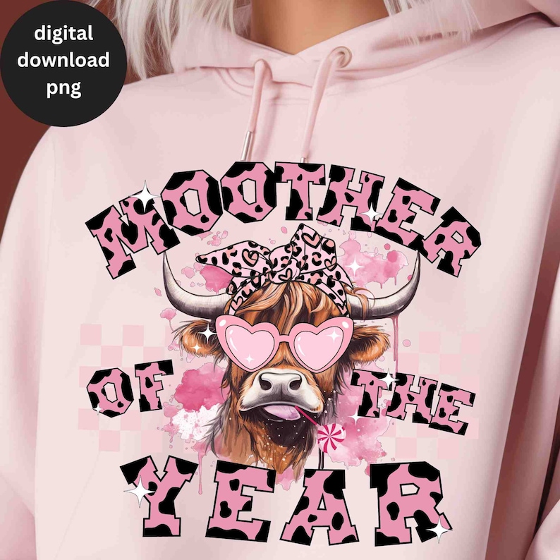 May include: Pink hoodie with a black and pink cow graphic and the text "MOOTHER OF THE YEAR".