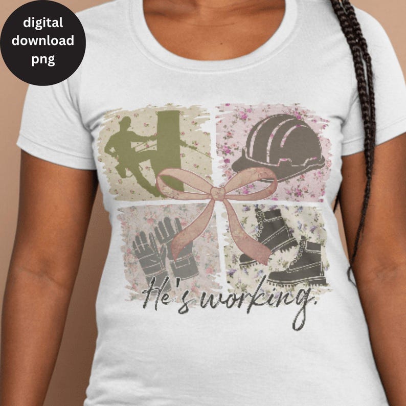 May include: A white t-shirt with a pink and brown collage design featuring a hard hat, work boots, gloves, and a silhouette of a person working on a utility pole. The text "He's working" is printed below the collage.