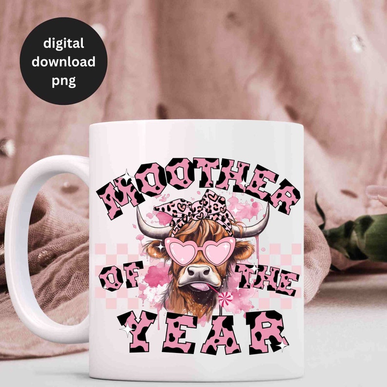 May include: White ceramic mug with a pink and black design featuring a cartoon cow wearing pink sunglasses and a pink bandana with black spots. The text "MOOTHER OF THE YEAR" is written in a pink and black font.