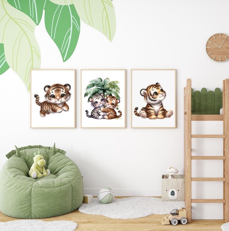 May include: Three framed prints featuring cute cartoon tiger cubs. The first print shows a tiger cub sitting with its paws crossed. The second print shows two tiger cubs hugging under a palm tree. The third print shows a tiger cub sitting with its head tilted up.