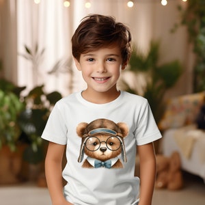 May include: A white t-shirt with a brown bear wearing a brown aviator hat, round glasses, and a blue bow tie.