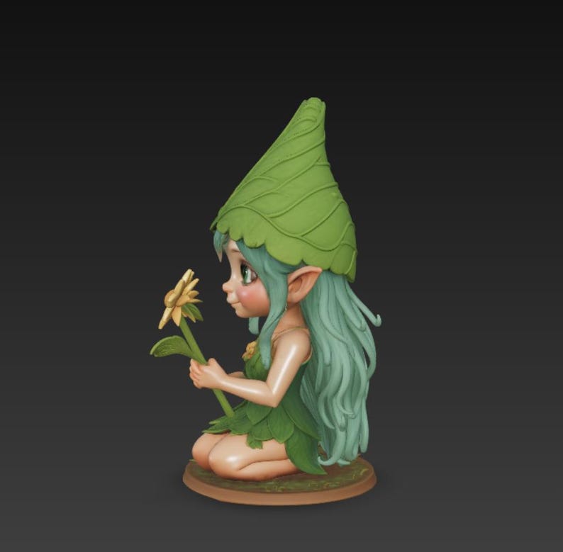 May include: A detailed figurine of a fairy with green hair, a leaf-shaped hat and dress, and a yellow flower. The fairy is kneeling on a brown base. The figurine is painted in soft, natural colours.