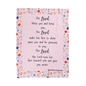 May include: A pink floral patterned throw blanket with a white text overlay. The text reads "The Lord bless you and keep you; The Lord make his face to shine upon you and be gracious to you; The Lord the Lord turn his face toward you and give you peace. Numbers 6:24-26"