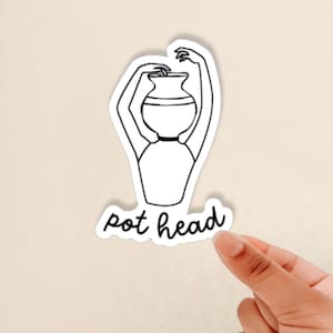 May include: A black and white line drawing of a person with a pot on their head. The text "pot head" is written below the drawing.