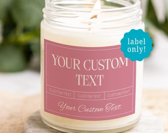 May include: A clear glass jar candle with a lit wick and a dusty rose rectangular label. The label features the text YOUR CUSTOM TEXT in a bold serif font, three smaller custom text fields, and the script text Your Custom Text at the bottom.