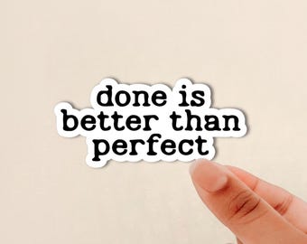 May include: A die-cut sticker with a white border and black text that reads done is better than perfect in a rounded, bold, lowercase font. The sticker has a smooth, matte appearance and is shaped to follow the contour of the three lines of text.