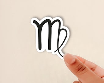 May include: A die-cut sticker featuring the black Virgo zodiac symbol printed on a white background. The symbol consists of a stylised letter M with a looped tail that curves upward and inward, creating a distinct astrological icon for the sign.