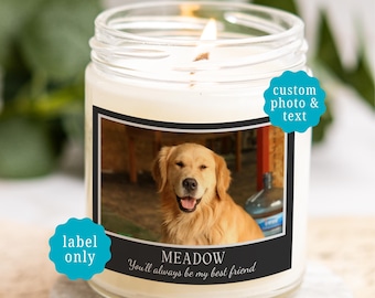 May include: A clear glass jar candle with a white wax fill and a lit wick. The label features a photograph of a golden retriever, the name MEADOW, and the text You'll always be my best friend. Two blue scalloped badges read custom photo & text and label only.