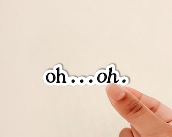 May include: A die-cut vinyl sticker featuring the black lowercase text "oh...oh." in a serif font. The sticker has a thin white border around the lettering, creating a clean and distinct outline against the background for easy application.