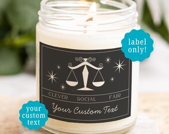 May include: A clear glass candle jar with a white wax fill and a lit wick. The black rectangular label features a white Libra scale icon, star accents, and the text CLEVER SOCIAL FAIR and Your Custom Text. Two teal circular badges read label only! and your custom text.