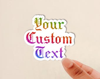 May include: A die-cut sticker featuring the words Your Custom Text in a gothic-style font. The lettering displays a vibrant rainbow gradient with a glittery texture, transitioning from green and yellow at the top to red, pink, and blue at the bottom.