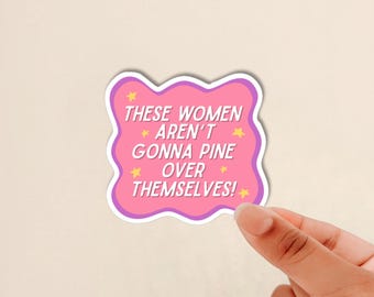 May include: A pink, wavy-edged sticker featuring the white text 'THESE WOMEN AREN'T GONNA PINE OVER THEMSELVES!' surrounded by small yellow stars. The sticker has a purple border and is presented against a plain, light-colored background.