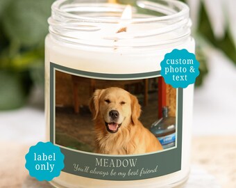 May include: A clear glass candle jar with a lit wick containing white wax. The label features a photograph of a golden retriever, the name MEADOW, and the text You'll always be my best friend. Two blue circular badges read custom photo & text and label only.