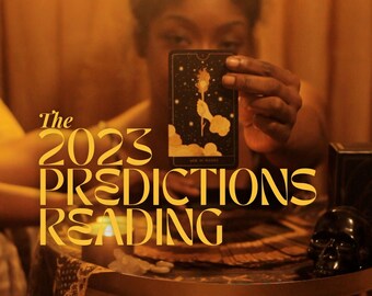May include: The 2023 Predictions Reading text in gold lettering on a dark background with a person holding a tarot card with a black background and gold accents. The card shows a hand reaching up to a flame.