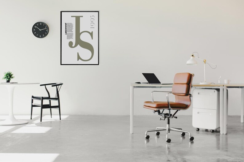 May include: A contemporary office setting featuring a white desk, a brown leather chair, and a black laptop. A framed poster with the letters "JS" and the year "1995" is on the wall. A black clock and a small plant are also present.