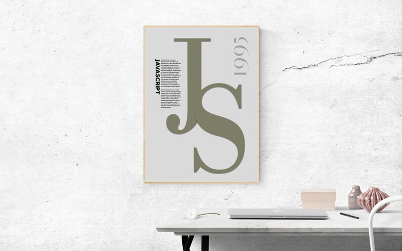 May include: A framed poster with a minimalist design featuring the letters "JS" in a muted green colour. The word "JAVASCRIPT" is printed vertically in black, with the year "1995" in grey. The poster is displayed on a white wall.