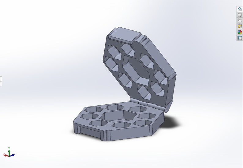 May include: A gray octagonal box with a hinged lid. The box has 10 compartments, each shaped like a hexagon. The lid is open, revealing the compartments.