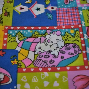 May include: A colorful fabric with a patchwork design featuring cartoon animals, flowers, and geometric patterns. The squares include a sleeping puppy, birdhouses, and floral elements in shades of blue, pink, green, and yellow.