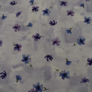 Purple Violet Petals on White and Purple Fabric