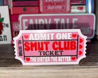 May include: A pink and white ticket with the text "ADMIT ONE SMUT CLUB TICKET THE DIRTIER THE BETTER" in black and red lettering. The ticket has a pink heart on each side.