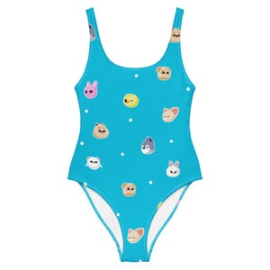 May include: A bright turquoise one-piece swimsuit featuring a repeating pattern of small, stylized cartoon animal faces in various colors including pink, yellow, brown, and grey, interspersed with tiny white polka dots across the entire fabric.