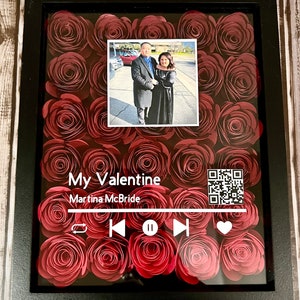 May include: A framed artwork featuring a photo of a couple, surrounded by red paper roses. The artwork includes the text "My Valentine" and "Martina McBride", along with a music player graphic and a QR code.