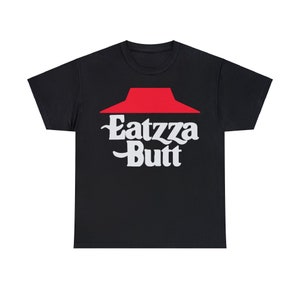 May include: Black t-shirt with a red logo resembling a pizza box top. The shirt features the words "Eatzza Butt" in white, stylized lettering. The design is centered on the front of the shirt.