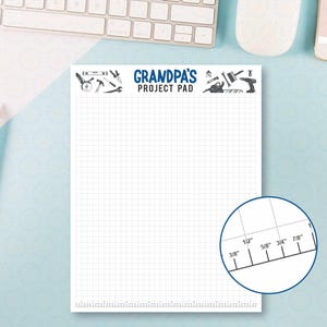 May include: A white notepad with a grid pattern and the text "GRANDPA'S PROJECT PAD" at the top, with tool illustrations. A ruler graphic is in the lower right corner. Pencils are on the left.