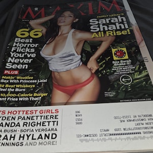 May include: A Maxim magazine cover from October 2012 featuring Sarah Shahi. The cover includes text such as 66 Best Horror Flicks You've Never Seen, Makin' Wookiee Sex With Princess Leia, 22 Best Whiskeys, and a list of names including Hayden Panettiere.