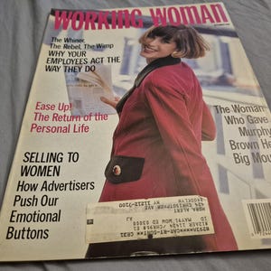 May include: A vintage magazine cover titled "WORKING WOMAN" featuring a woman in a red blazer. The cover includes text about employees, personal life, and advertising. The magazine is from the 1990s.